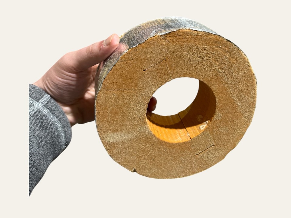 AccuThermax™ Phenolic Pipe Support Block — 120 kg/m³ foil-faced support block in hand