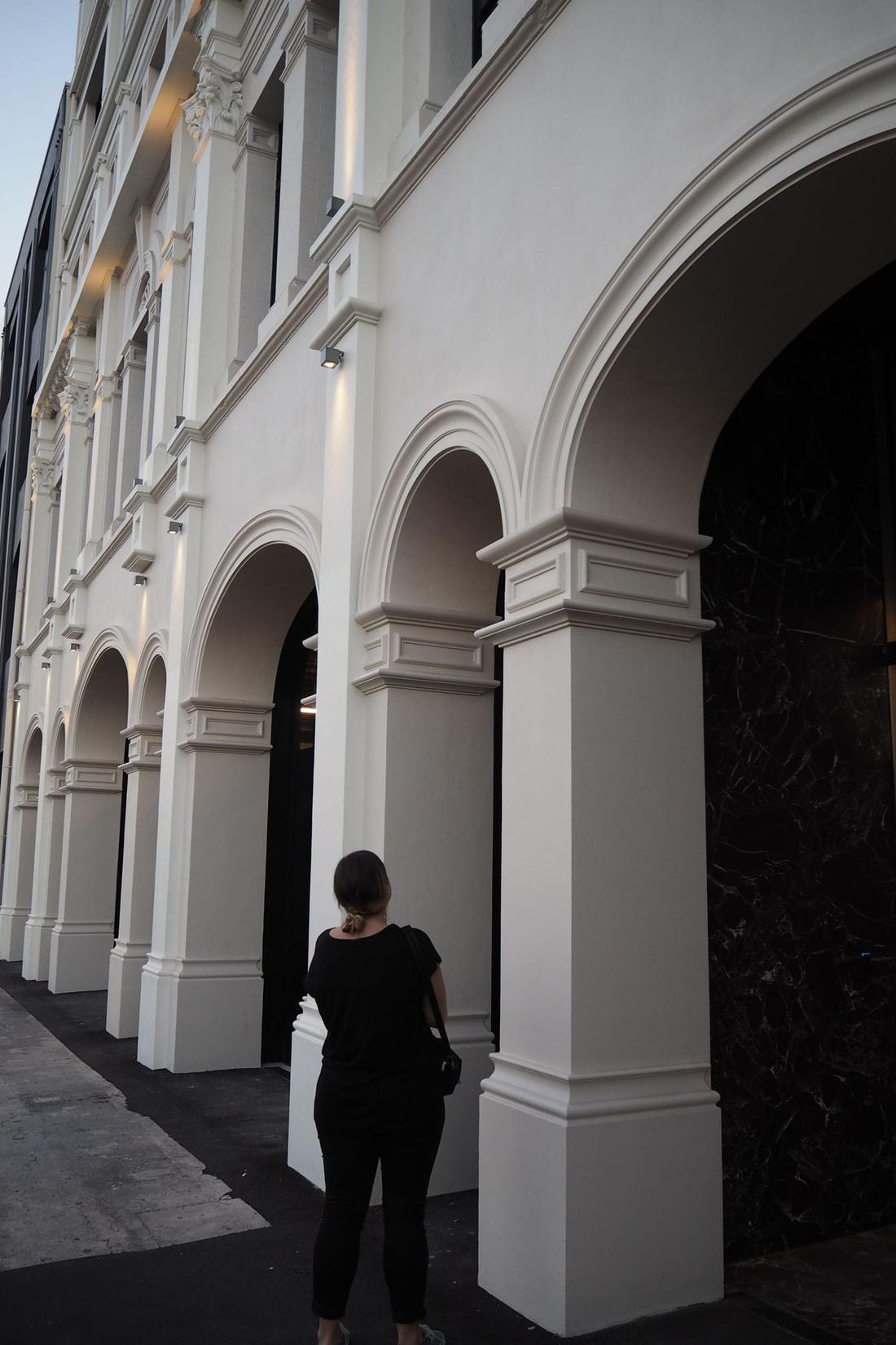 View of the Quay Building street-level facade and decorative moulding details.